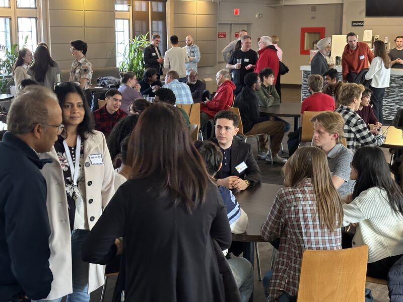 full room of students and faculty in a networking event
