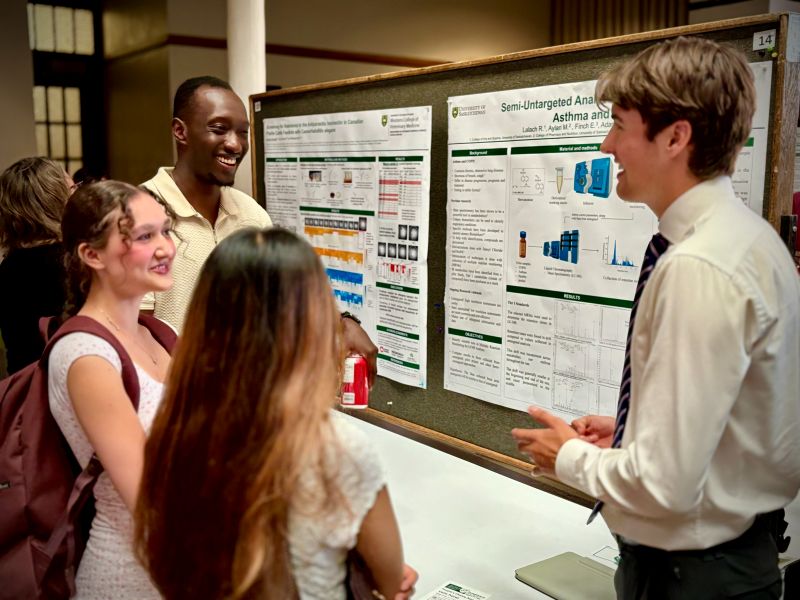presenter with group at symposium